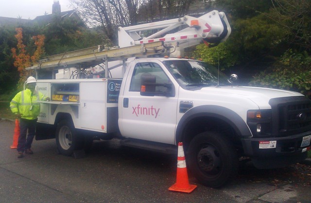 Comcast tech helping children in Ethiopia here posts with his Comcast truck