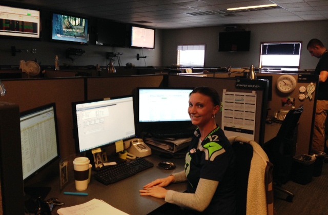 Jennifer Wolever sitting at her desk at the Everett XOC