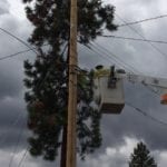 Comcast tech in a bucket truck