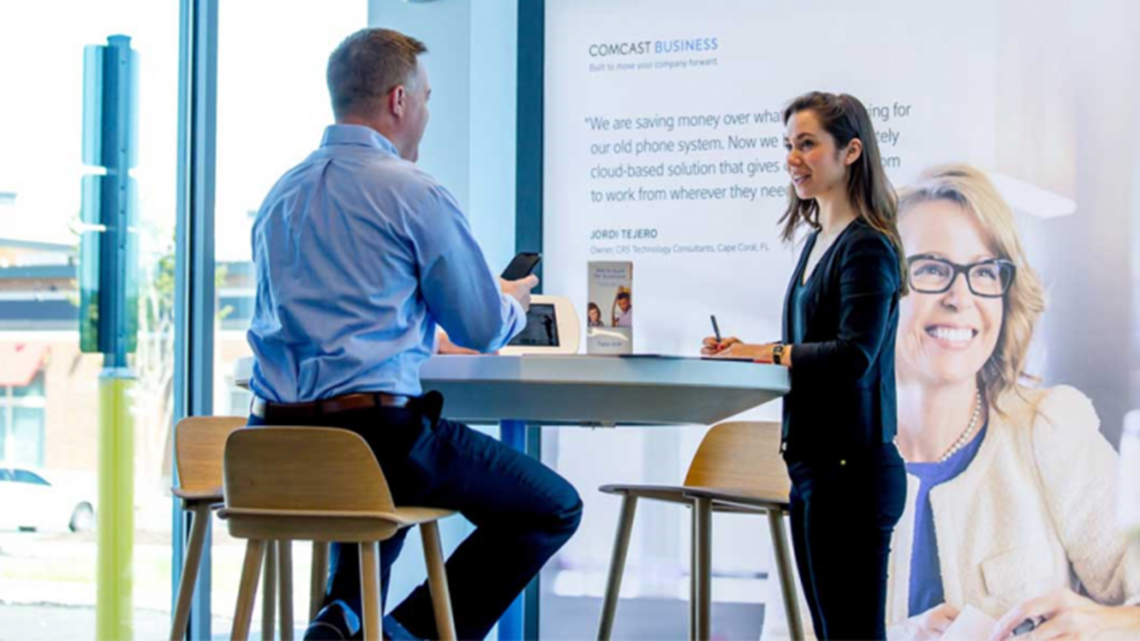 Male and Female having a conversation at an Xfinity Store.