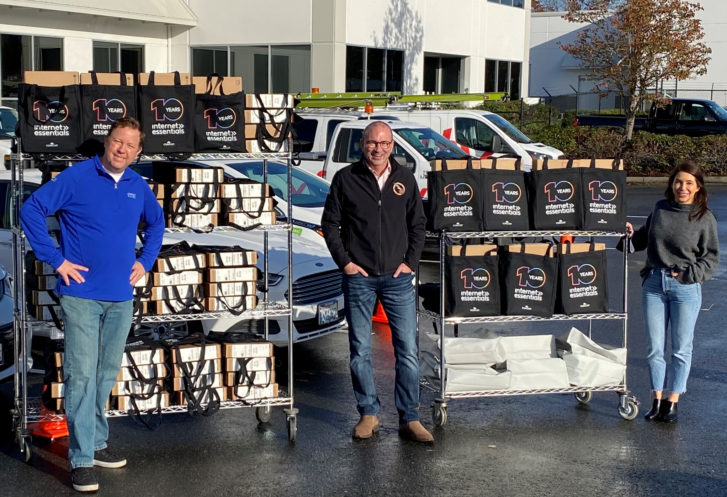 Comcast employs Terry Davis & Carla Carrell stand with Mike Schindler from Operation Military Family and laptop donations.