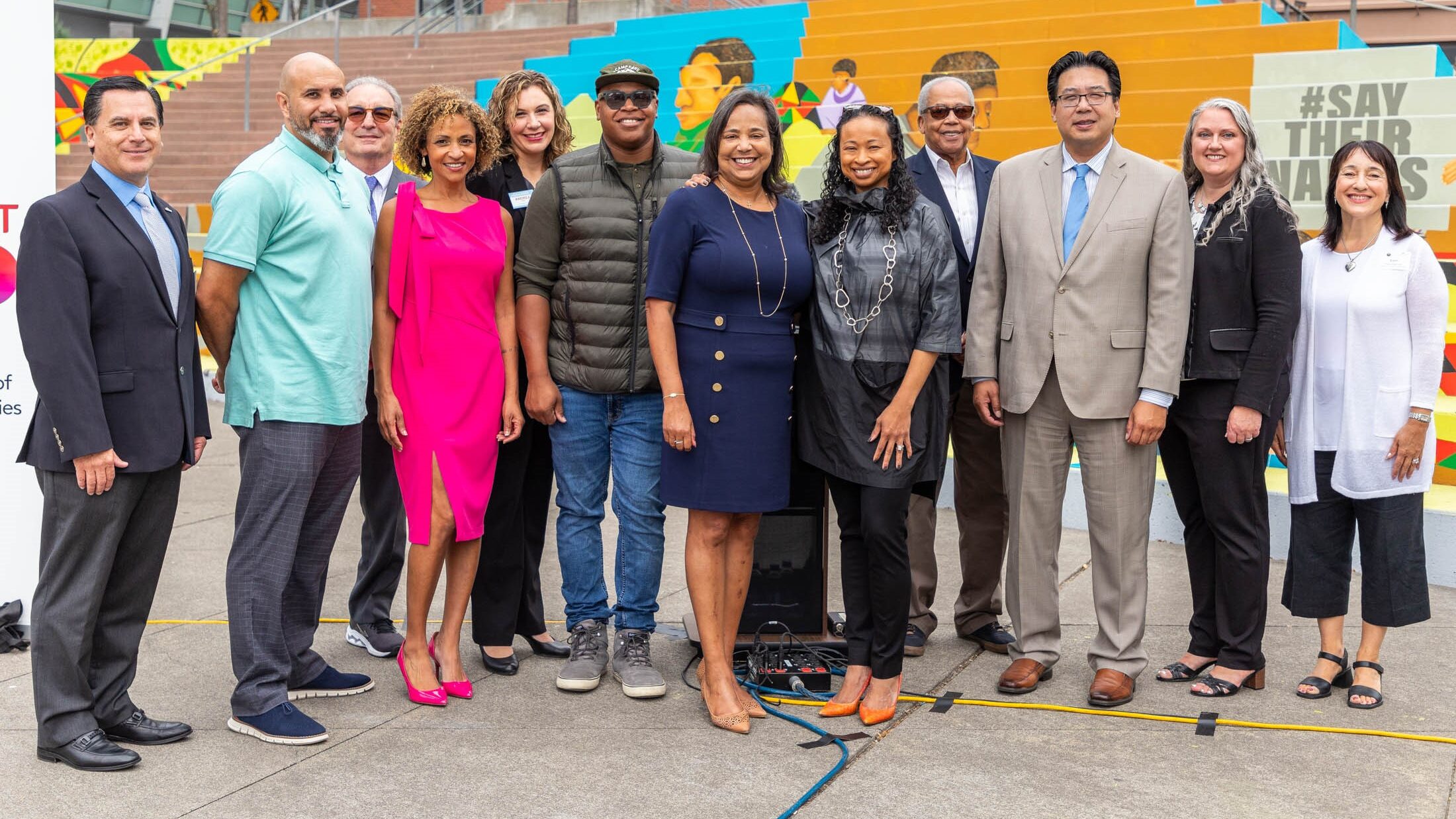 Comcast and Tacoma city leaders pose in Tollefson Square.