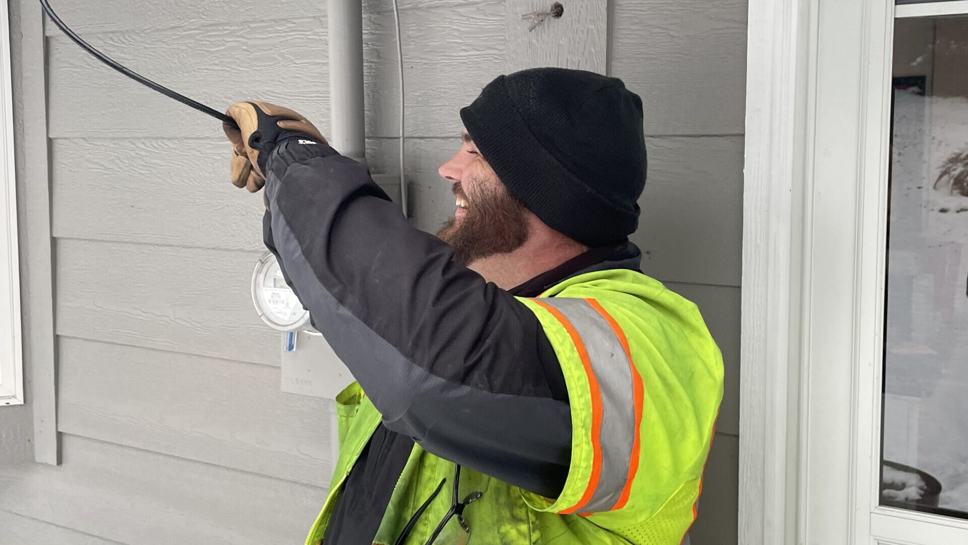 Robert Fisher works on cable at a home.