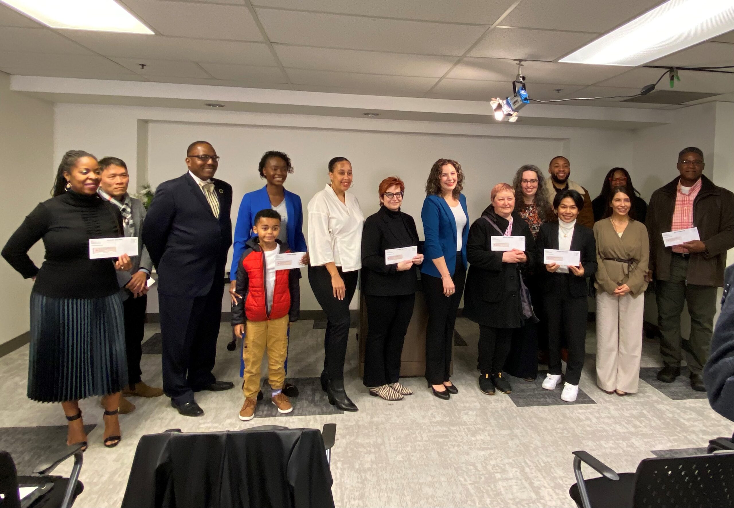 Recipients of the Thrive Tacoma Business Fund grants pose in a room.