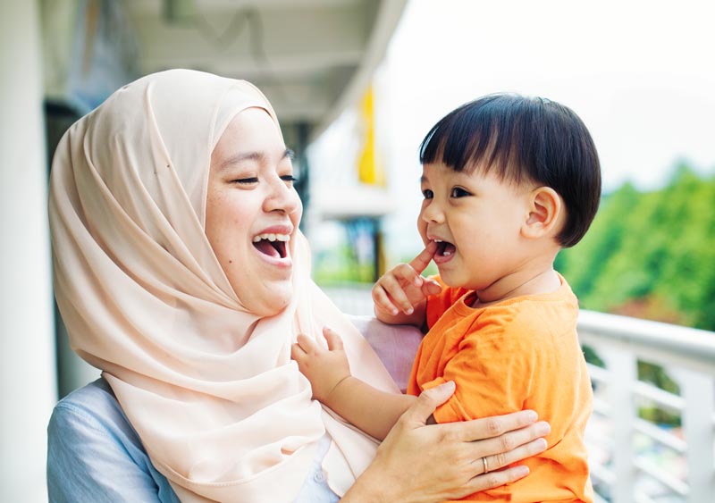 A woman works with a young child.