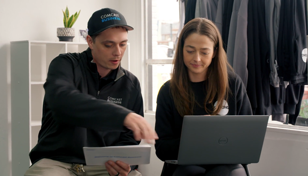 Natalie Ceis and a Comcast Business rep both with laptops.