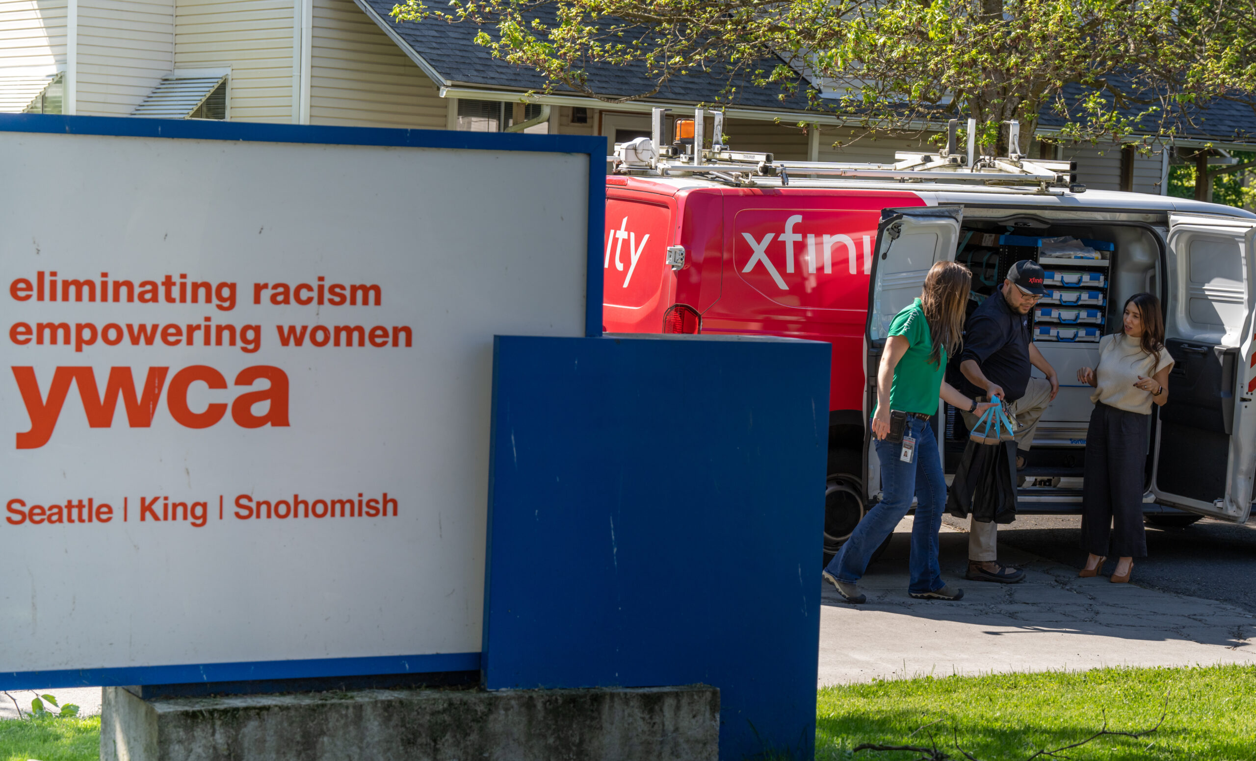 The YWCA sign and an Xfinity van. 