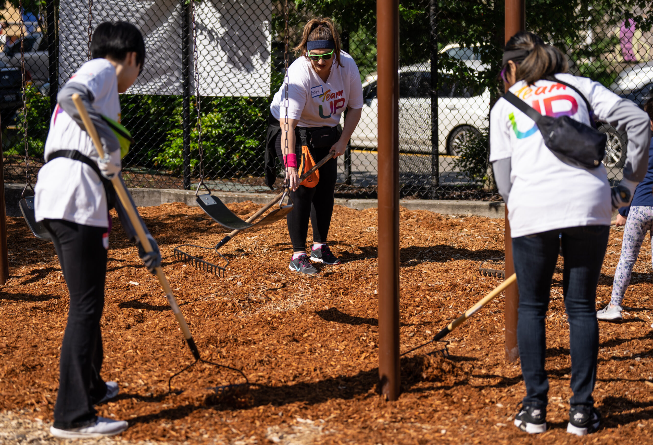 Comcast employees dig in a playground.