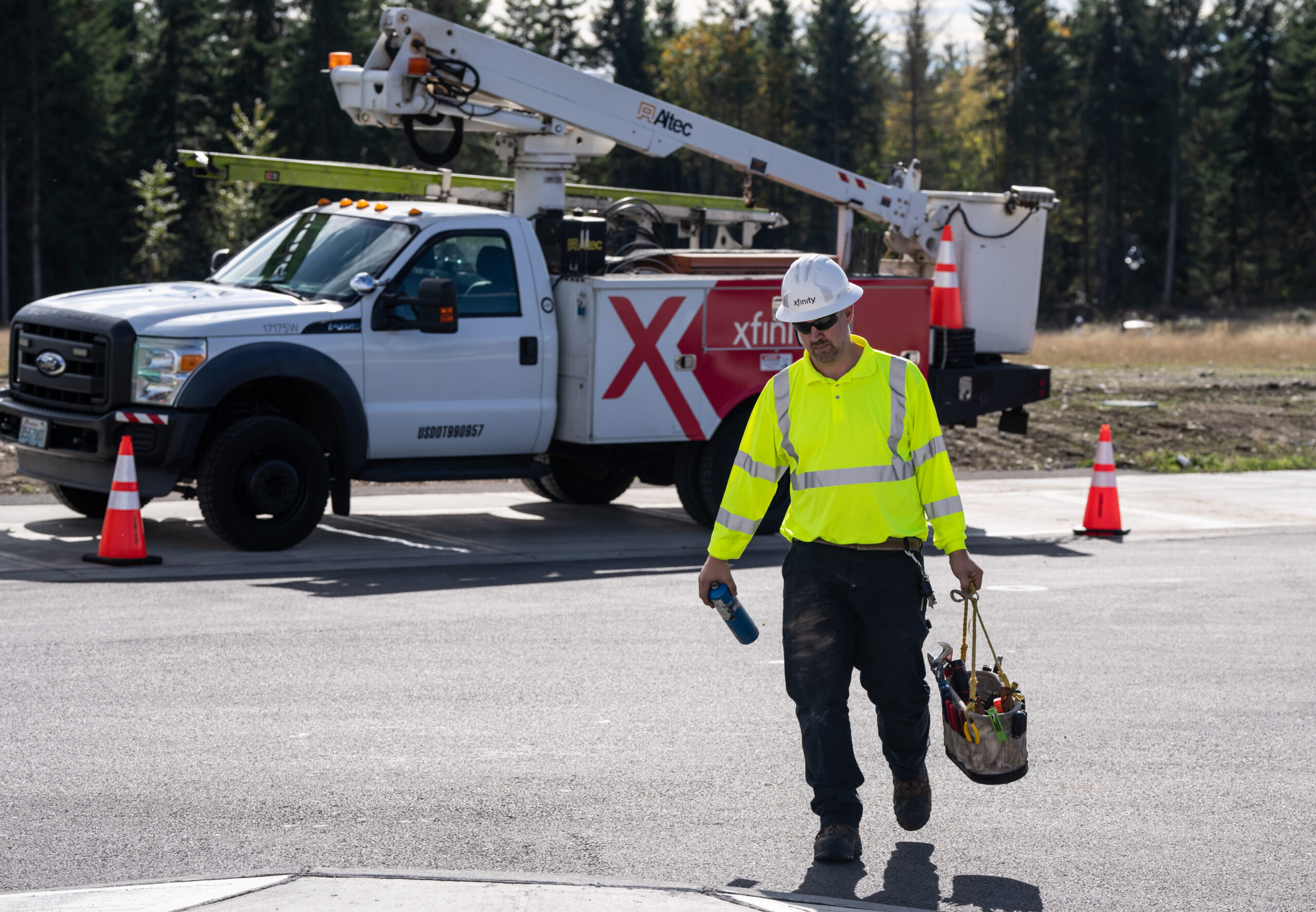 A Comcast technician in front of a Comcast truck.