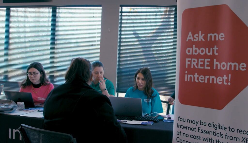 Digital Navigators sit at a table with computers. 