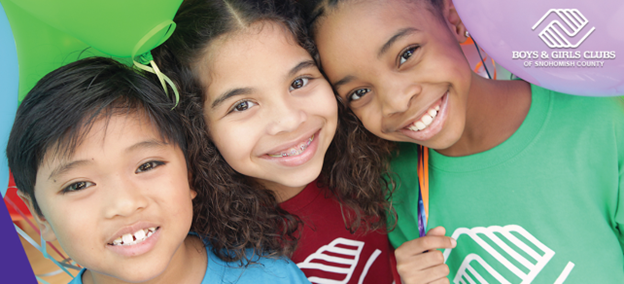 Three kids smiling wearing Boys & Girls Clubs shirts.