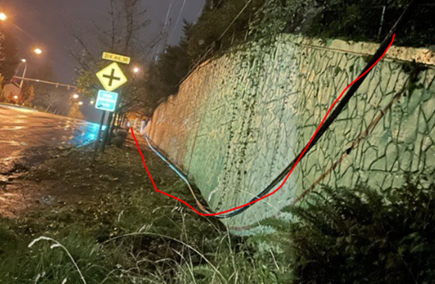 A damaged cable fiber line on a sidewalk.