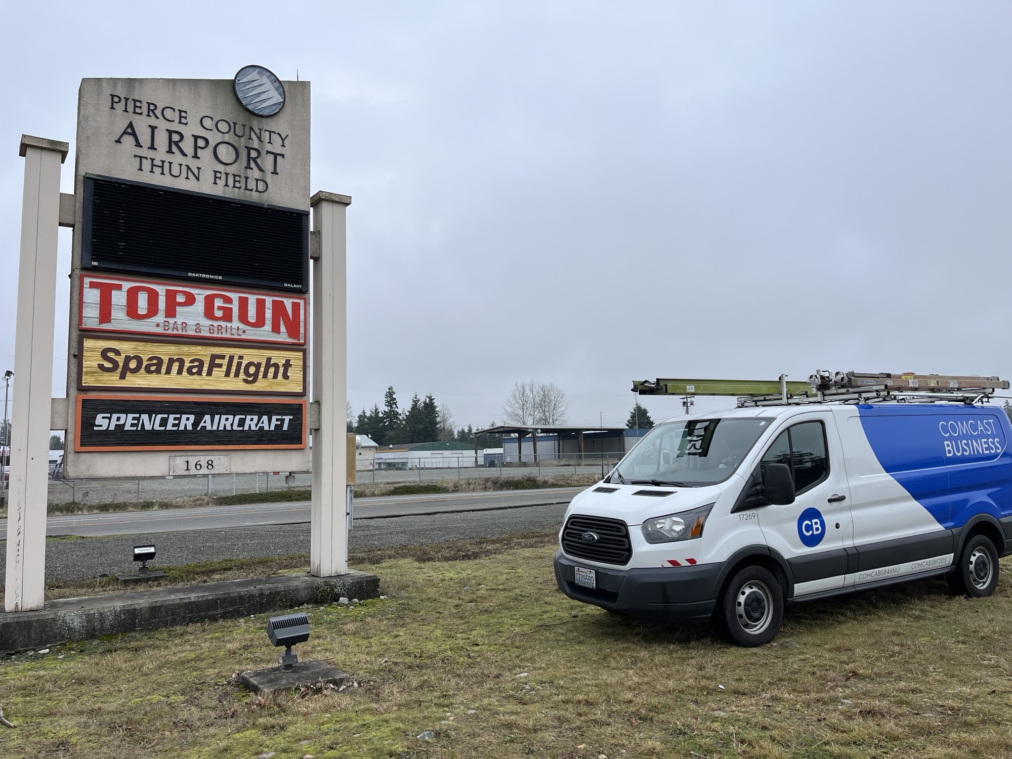 A Comcast Business van in front of the Thun Field sign.