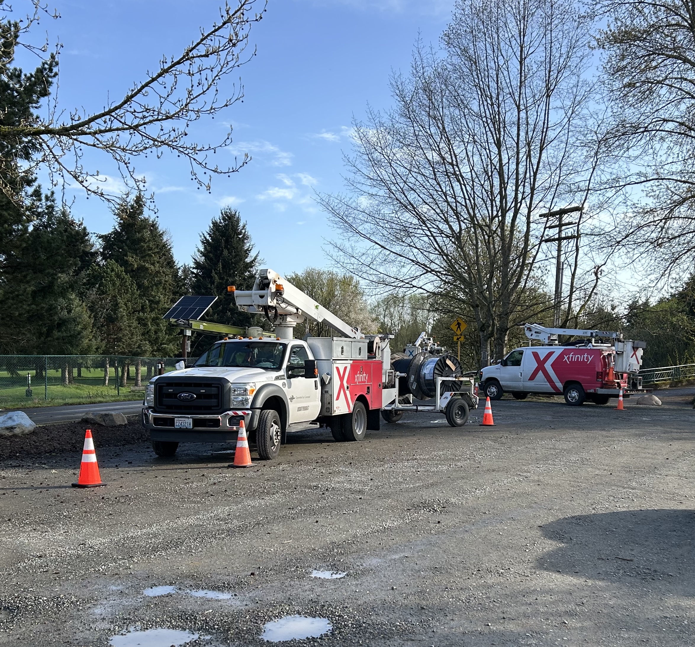 An Xfinity truck by the side of the road.