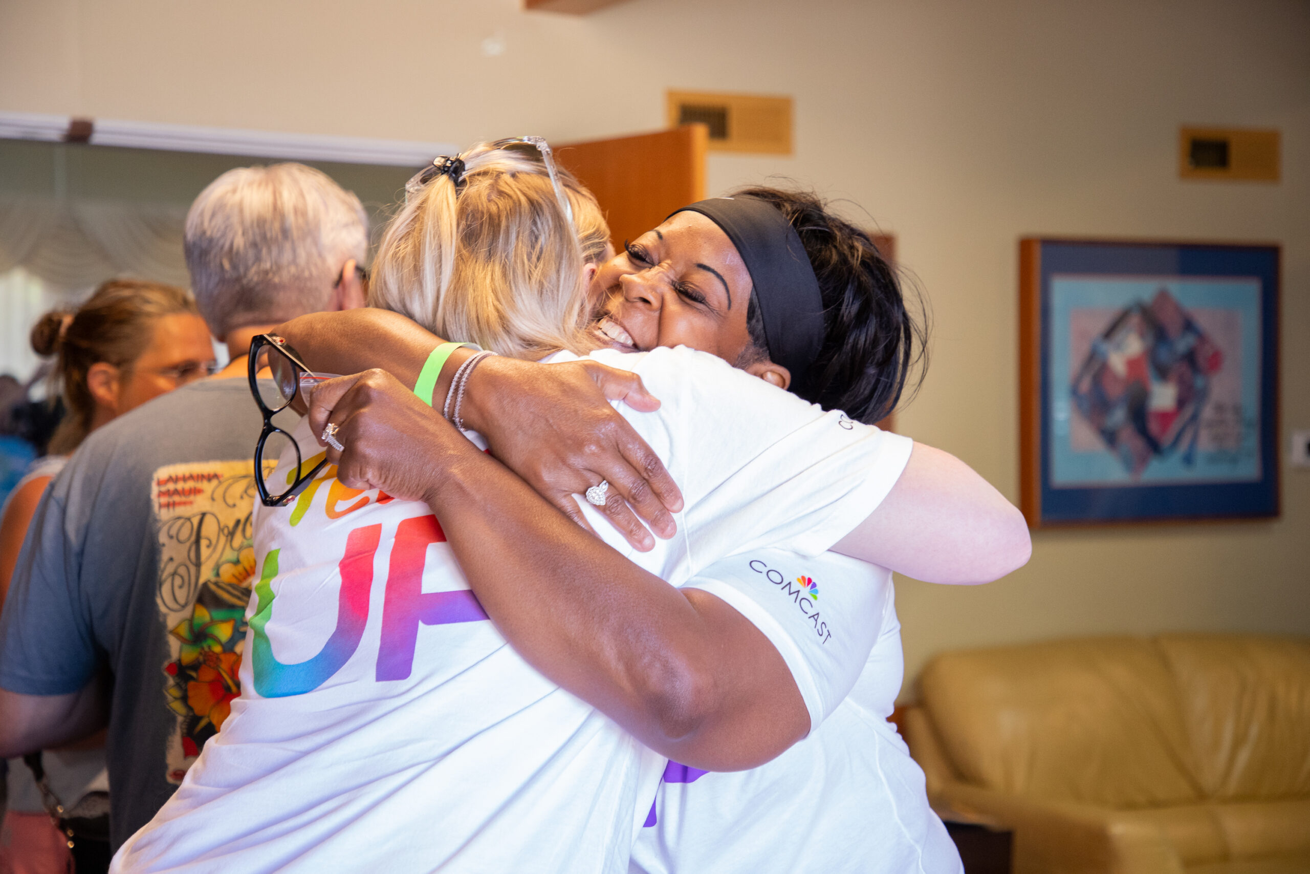 Team Up Comcast volunteers hug.