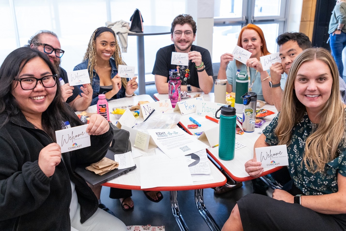 Kent teachers smile around a table.