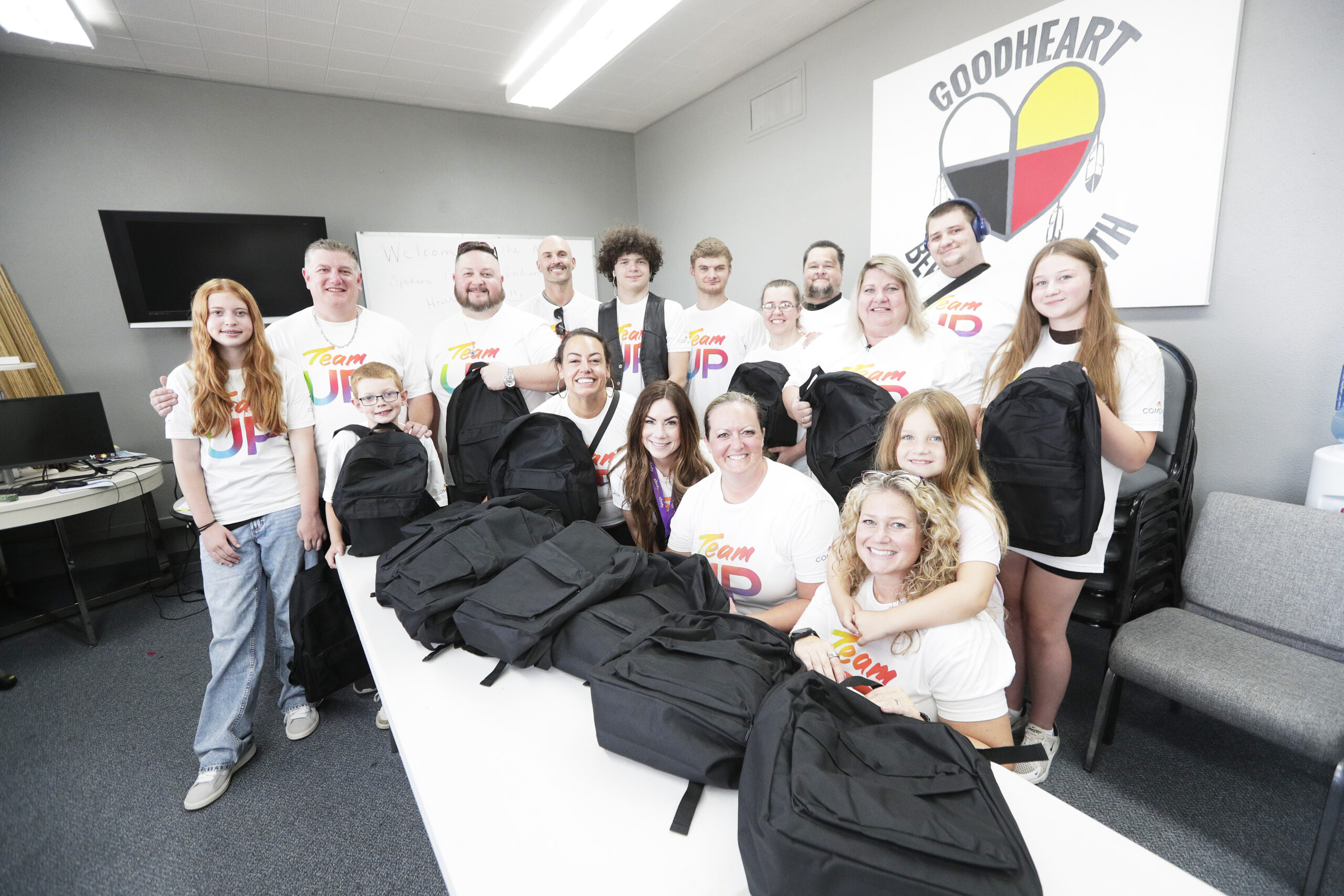 Comcast Team UP employees pose with backpacks.