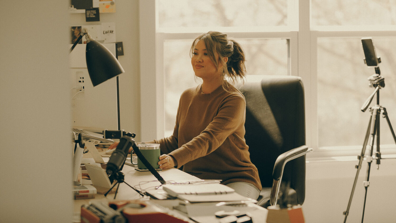 A woman works at a desk.