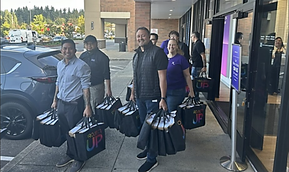 People carrying bags of laptops. 