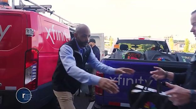 People gathering bags of laptops.