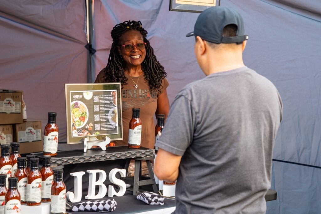Junebug sauce owner Gail at a farmer's market.